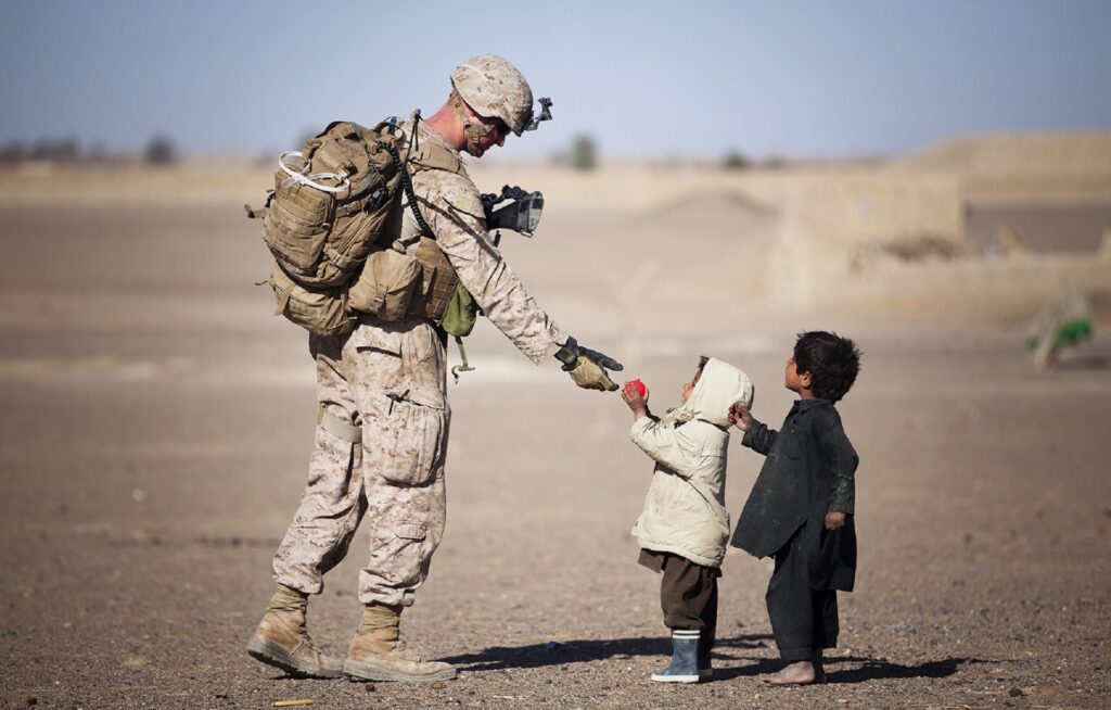 Compassionate soldier with small children